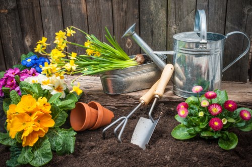 Local gardeners trimming hedges and maintaining flower beds in Ratcliff
